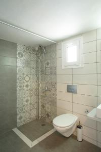 a bathroom with a toilet and a shower at Spacious Apartment in Plakias in Plakias