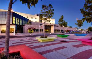 a courtyard in front of a building with colorful benches at Hotel Eurosol Alcanena in Alcanena