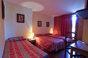 Postel nebo postele na pokoji v ubytování Hotel Dolonne