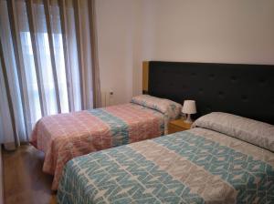 Кровать или кровати в номере Manolo piso