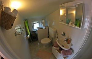a small bathroom with a toilet and a sink at Room and Apartment Doris in Umag