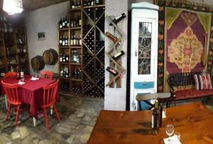 a dining room with a table and a wine cellar at Omsi House in Telavi
