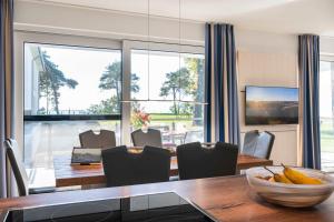 a dining room with a table and a large window at Appartement Seemöwe - Oase am Haff in Garz