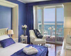a bedroom with a bed and a view of the ocean at Hotel Tiffany's in Riccione