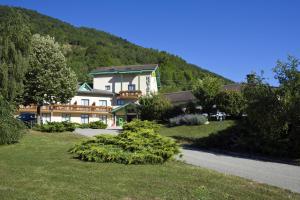 a large house in the middle of a green mountain at Logis Murtel in La Mure
