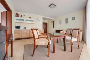 a living room with a dining room table and chairs at Avenue, Sun & Snow in Świnoujście