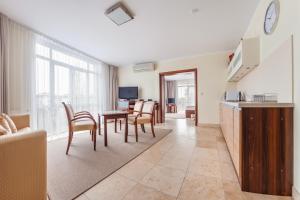a kitchen and living room with a table and chairs at Avenue, Sun & Snow in Świnoujście