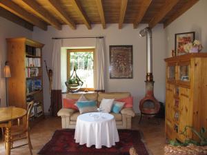 a living room with a couch and a table at La Haute Gilberdière in Sartilly
