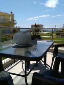 a vase sitting on top of a table on a balcony at Crystallia SeaSide Maisonette by RentalsPro- Nea Moudania in Nea Moudania