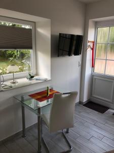 an office with a desk and a chair and a window at Hof Keske in Peissen