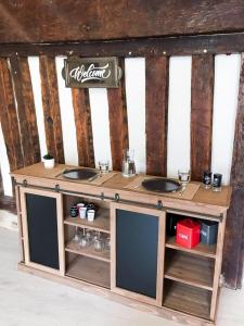 a wooden counter with two sinks in a room at L'hôte en pierre in Blois