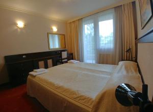 Кровать или кровати в номере Aparthouse Borovo