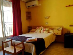 Postel nebo postele na pokoji v ubytování Hotel Alaska