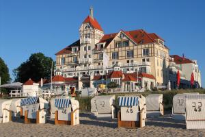 a group of chairs on the beach in front of a building at Haus Meeresblick Whg. 4.11 in Kühlungsborn