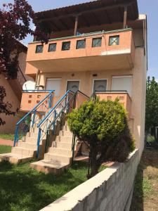 a house with stairs in front of it at Dimitra’s and Nasia’s Villa in Psakoudia