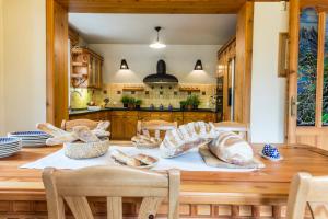 a kitchen with a wooden table with bread on it at udanypobyt Dom Z Ogrodem in Zakopane