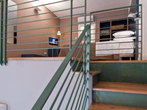 a staircase with a metal railing in a room at Hotel Piazza Bellini & Apartments in Naples