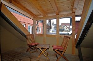 two chairs and a table on the porch of a house at Gästehaus Tanzwerder in Hannoversch Münden