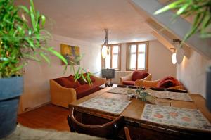 a living room with a wooden table and chairs at Gästehaus Tanzwerder in Hannoversch Münden