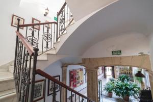 a staircase in a building with a stair case at Casa Palacio de los Leones in El Puerto de Santa María