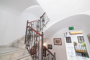 a spiral staircase in a home with white walls at Casa Palacio de los Leones in El Puerto de Santa María
