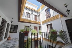 a courtyard in a house with potted plants at Casa Palacio de los Leones in El Puerto de Santa María