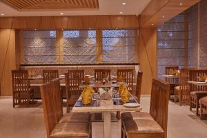 a dining room with a table and chairs and a table and chairsktop at Shivas Galaxy Hotel in Devanhalli