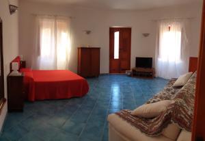 a hotel room with two beds and a television at A Casa Tunna in Pachino