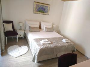 a bedroom with a bed with two towels on it at Studio Sfinga in the heart of Diocletian's palace in Split
