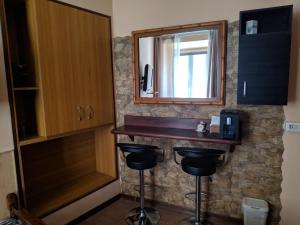 a bathroom with a counter and a mirror and stools at Gina B&B in Rome