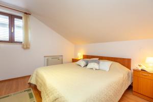 Postel nebo postele na pokoji v ubytování Apartments Mondo