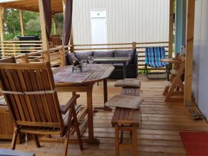 a wooden deck with a wooden table and chairs at Mobile Homes Aurea Maris - Kamp Dole Živogošće in Živogošće