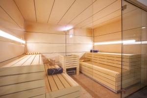 a sauna with two benches and a glass wall at Grupotel Maritimo in Port d'Alcudia