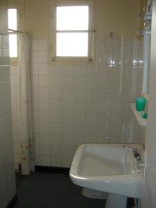 a bathroom with a sink and a tub and a window at Villa Etche Xuria in Biscarrosse-Plage +9 photos