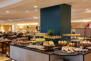 a buffet line with desserts on display in a hotel lobby at Grupotel Maritimo in Port d'Alcudia