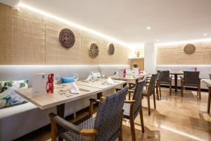 a dining room with long tables and chairs at Grupotel Maritimo in Port d'Alcudia