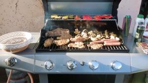 a grill with meat and other food on it at Görbe Vendégház magyar klasszika in Tarcal