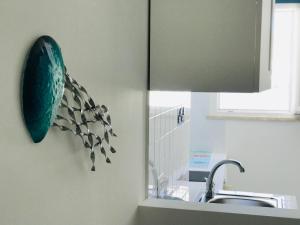 a kitchen with a green plate on the wall next to a sink at Acquario - Immobilevante in Ponza +23 photos