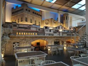 a restaurant with tables and chairs and a building at Hotel El Salt in Valderrobres