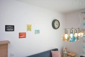 een woonkamer met een bank en een klok aan de muur bij Ferienwohnung Küstenflair in Ostseebad Sellin