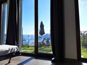 a bedroom with a window with a view of a yard at Le Camere Della Vecchia Osteria in Stresa
