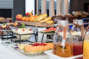 a buffet of food with fruit and drinks on a table at Melia Sitges in Sitges