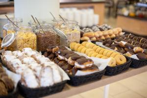 a table with many different types of donuts and jars at Grupotel Maritimo in Port d'Alcudia