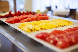 a buffet with two trays of different types of fruit at Grupotel Maritimo in Port d'Alcudia