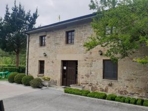 a stone building with a door in front of it at Casa da Ponte in Ferreira