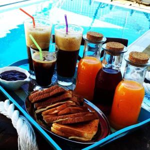 a tray of breakfast foods and drinks on a table at Castri Village Kythira Quality Resort in Agia Pelagia