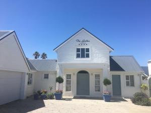 a white house with a sign on top of it at The Gables Hermanus in Hermanus