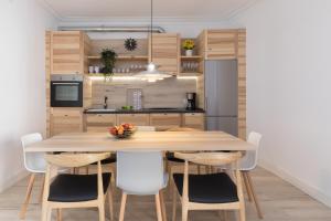 a kitchen with a large wooden table and chairs at Casa Cosi - Eixample 3 in Barcelona
