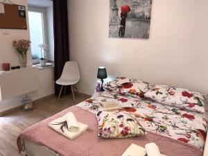 a bedroom with a bed and a table with books at Studio Apartment Legcevic in Kaštela
