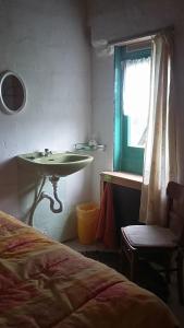 a bedroom with a sink and a bed and a window at shepherds cottage in Euscheid
